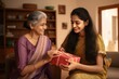 © AJay - indian ethnic loving mother and daughter exchanging a gift box