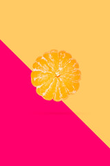 Poster - Peeled mandarin or clementine isolated on soft peach color background