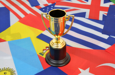 Wall Mural - Gold champion cup on national flags background. 