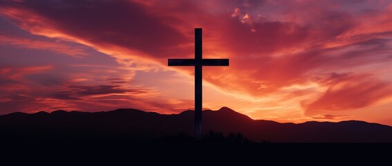 Silhouette of a cross on against a colorful sunset sky