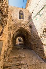 Vertical View Of A Picturesque Alley Featuring A Pointed Arch In The Muslim Quarter Of The Old City Of Jerusalem