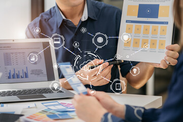 Creative team web designer planning application development for web mobile phone with customer breif and color code at office.