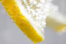 Extreme Close Up Of A Slice Of Lemon Floating In Sparkling Water
