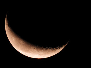 Wall Mural - moon in wanning crescent phase with dark sky in the background 