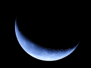 Wall Mural - moon in wanning crescent phase with dark sky in the background 