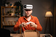 © Andrii Lysenko - Man recording a how to video review about VR Glasses or virtual reality headset at home office.