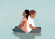 © fStop - Boy and girl sitting cross-legged back to back