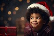 A african american boy in a Santa hat against the background of a Christmas tree and Christmas lights with gifts
