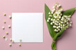 Invitation or greeting card mockup with envelope and lily of the valley flowers.