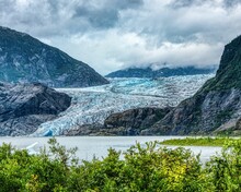 Mendenhall Glacier In Juneau, Alaska Surrounded By Majestic Mountains