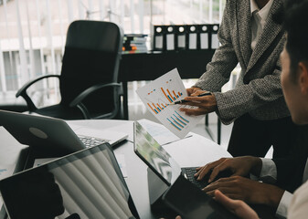 Close up of Business team analyzing income charts and graphs with modern laptop computer. Business analysis and strategy concept.