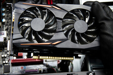 Poster - Top view of a graphics card being held by a technician, repairing a computer.