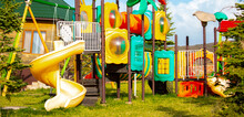 Bright Playground In The Park. Playground With Slides And Swings For Children.