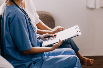 Caring doctor teaches female patient to use mobile healthcare app. Retired lady sitting in hospital exam room looking at cell screen learning to download health tracker for senior citizens. Copy space
