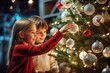 © Volodymyr - Happy boy and girl, brother and sister, decorate the Christmas tree