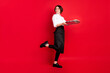 canvas print picture - Full length photo of dreamy nice young woman hold tray service staff isolated on red color background