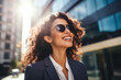 © Natalia Klenova - Confident smiling confident professional businesswoman leader wearing suit and sunglasses thinking of success, dreaming of new goal outdoor.
