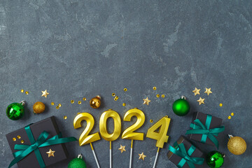 Wall Mural - Christmas holiday concept with 2024 new year, decorations, gift boxes and ornaments on dark background. Top view, flat lay