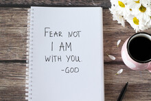 Fear Not I Am With You, God. Handwritten Text In Notebook With Flowers And Cup Of Coffee On Wooden Table. Inspiring Bible Verse. Christian Concept Of Comfort, Peace, And Love Of Jesus Christ.Top View.