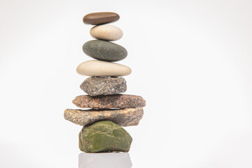 Wall Mural - pyramid of stacked stones on a white background. stabilization and balance in life