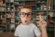 © BillionPhotos.com - Excited little school child with eyeglasses in library