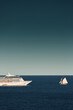 Monaco, vintage sail yacht and huge cruise liner are in sea at sunset, huge motor ship, wealth life of billionaires 