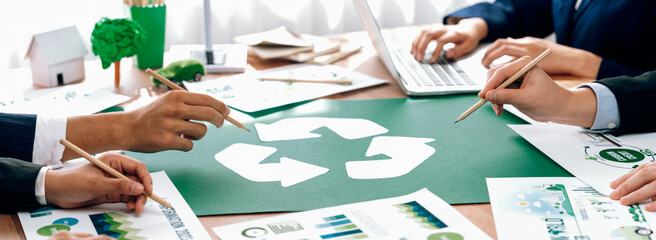 Wall Mural - Group of business people planning and discussing on recycle reduce reuse policy symbol in office meeting room. Green business company with eco-friendly waste management regulation concept.Trailblazing