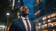 young african american businessman standing at city skyscrapers background and looking in future, entrepreneur planning business
