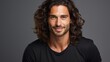 Portrait of handsome latino man with long curly hair.