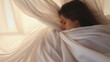 © Liana - Woman resting peacefully wrapped in soft white sheets, embodying relaxation and calm