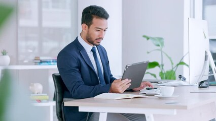 Poster - Businessman using digital tablet, typing on computer keyboard and planning global business strategy. Confident professional sitting alone in office, multitasking and using technology to innovate idea