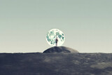 A man standing on the moon, moon over the mountains, silhouette of a person on the moon