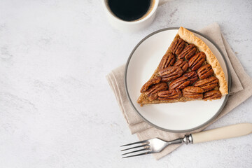 Wall Mural - Plate with piece of tasty pecan pie on light background