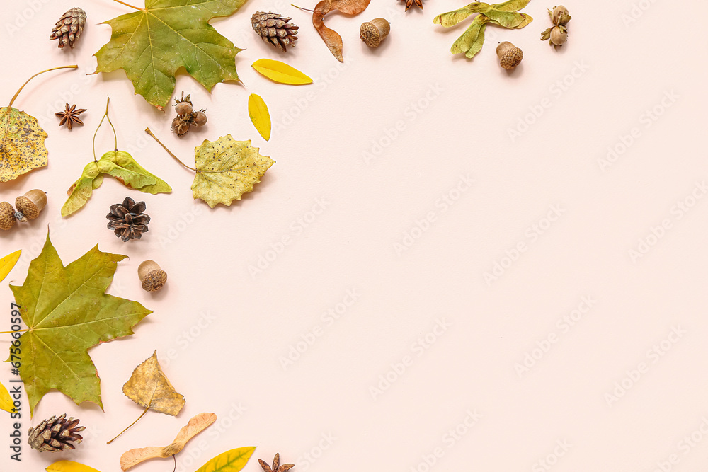 Beautiful autumn composition with leaves, pine cones and acorns on pink background