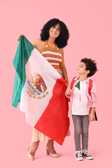 Canvas Print - Little boy and his mother with Mexican flags on pink background