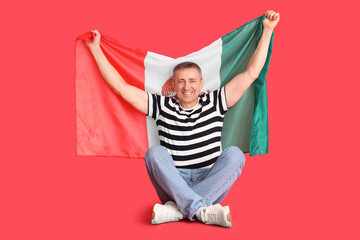 Poster - Mature man with Mexican flag sitting on red background