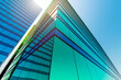 © sv_production - High-rise modern building made of glass against the sky.