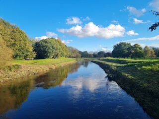 River in the park on sunny day with blue sky