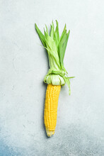 Fresh Yellow Cobs Of Organic Corn On Gray Concrete Background. Top View.