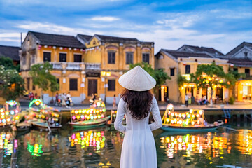 asian woman wearing vietnam culture traditional at hoi an ancient town, vietnam. hoi an is one of th