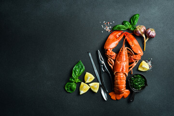 Wall Mural - grilled lobster with lemon and basil on a black slate board. on a dark wooden table