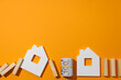 © Atlas - Houses, wooden blocks and cash on orange background, space for text