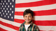 Hispanic,Mexican boy happy proud family standing by American flag. American immigration and United States refugee crisis concept as people on a border wall with a US flag as a social issue refugees 