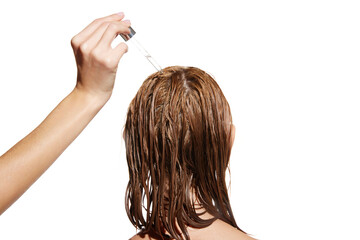 Female hand applying oil, serum on wet hair for repairing damaged hair against white studio background. Concept of beauty, hair care, treatment, natural cosmetics. Copy space for ad