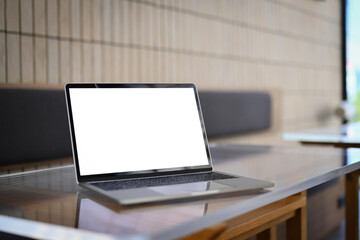 Poster - Laptop computer with white empty screen on wooden table at meeting room