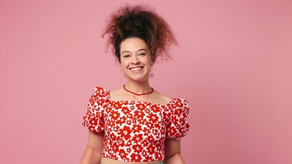 Canvas Print - Excited cheerful satisfied positive fun young latin woman wear red casual clothes showing thumbs up gesture like sign isolated on pastel plain light pink background studio portrait. Lifestyle concept