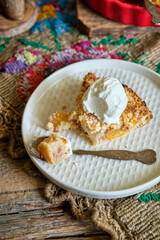 Sticker - Peach and plum streusel pie with ice cream, side view, wooden background, rustic.