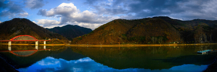 Wall Mural - Danyang South Korea autumn landscape at Subyon Water Park with Gosu Daegyo Bridge over Chungju Lake in Chungcheongbuk-do, Korea, with distant view of Sobaeksan Mountains National Park