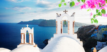 White Church Belfries And Volcano Caldera With Sea Landscape, Beautiful Details Of Santorini Island, Greece With Flowers