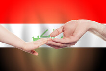 Iraqi Baby And Parent Hands On The Background Of Flag Of Iraq Help, Aid, Support, Charity Concept